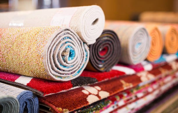 Stack of traditional colorful carpets in carpet shop, nobody